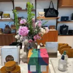 sezane store interior featuring purses and candles