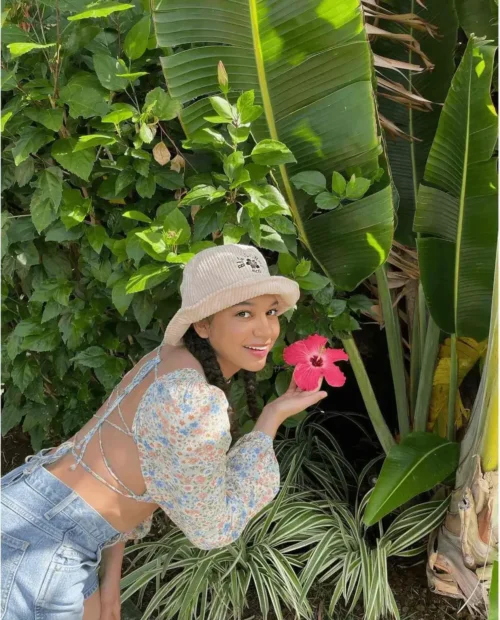 woman wearing a capsule wardrobe acessory bucket hat