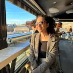 woman in sunglasses and a plaid coat