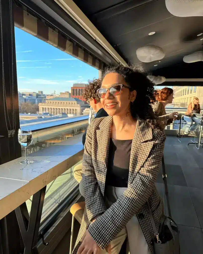 woman in sunglasses and a plaid coat