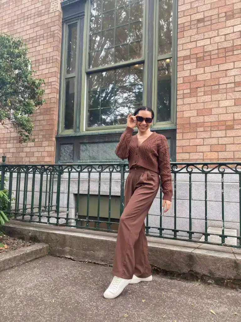 woman in brown trousers and cardigan chic outfit