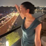 woman in silk summer dress over pier