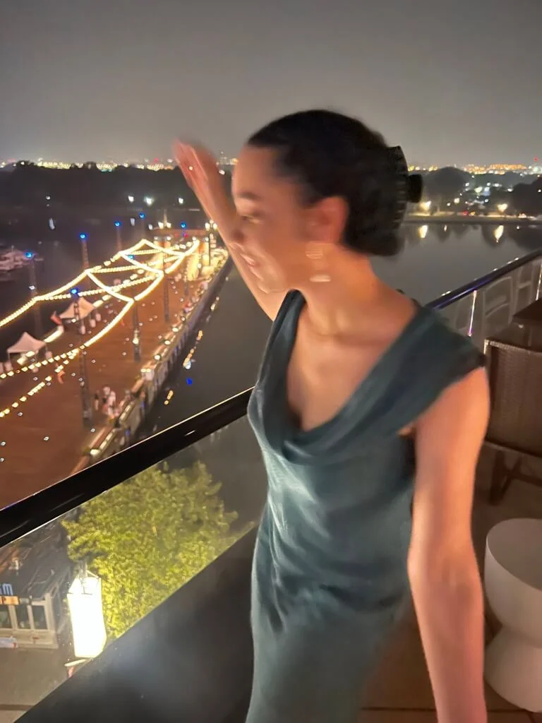 woman in silk summer dress over pier