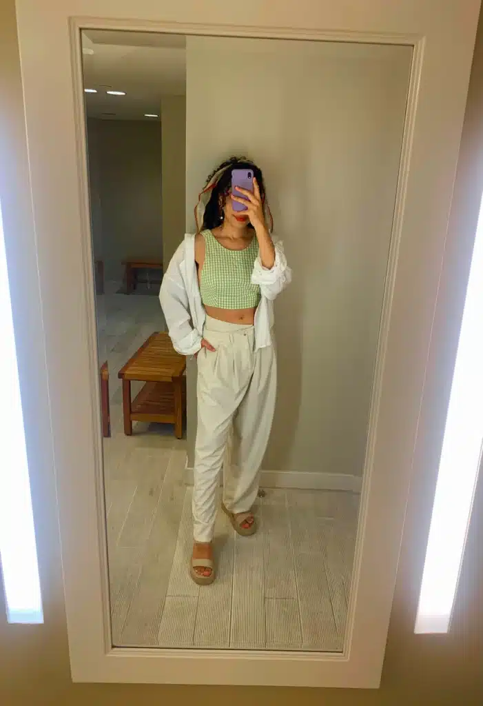petite woman in tan trousers and gingham crop top with neutral sandals