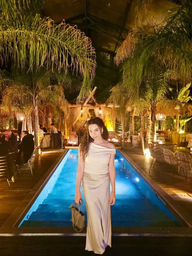 petite outfit idea woman wearing silk maxi skirt and off shoulder top