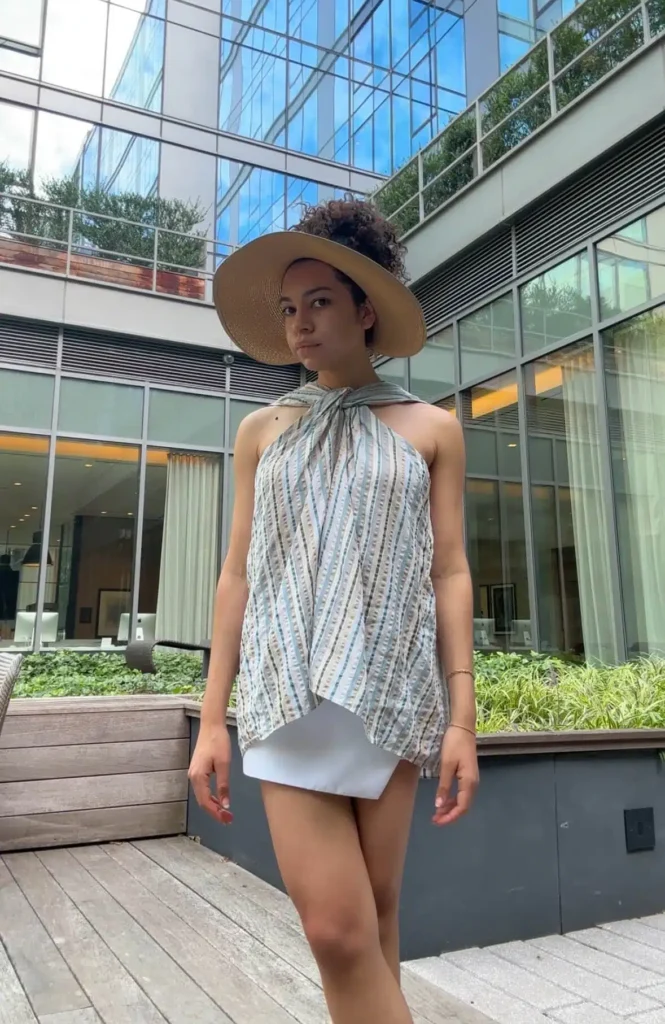 BTNO Review featuring woman in rented top from EENK and white mini skirt