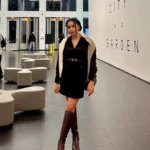 Woman in art gallery wearing elegant brown dress petite studio review