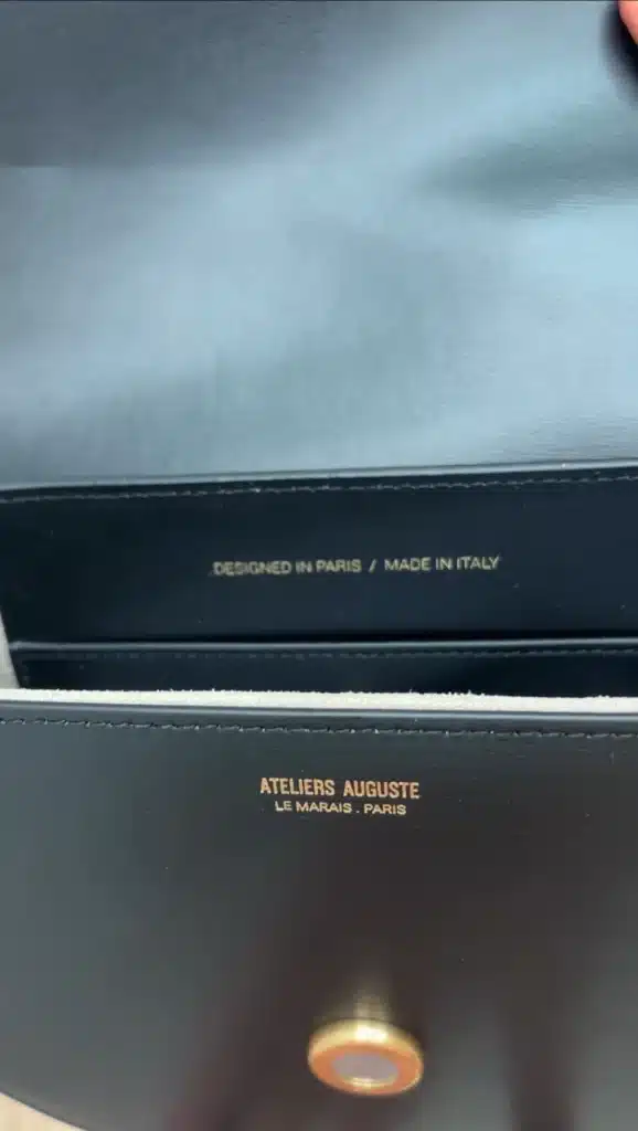 inside leather purse showing designed in paris made in italy stamp
